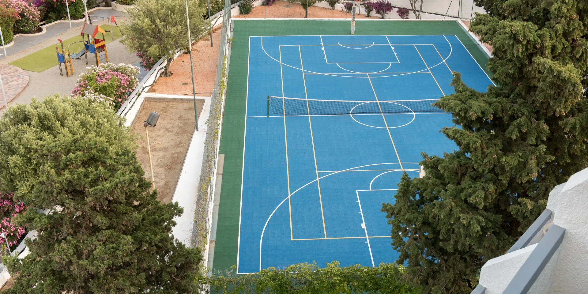 Campo polivalente blu con area giochi vista dall'alto