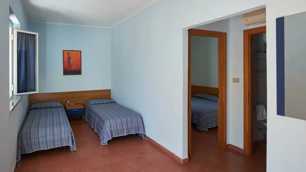 Camera con due letti singoli e camera attigua con letto matrimoniale, pavimento in cotto