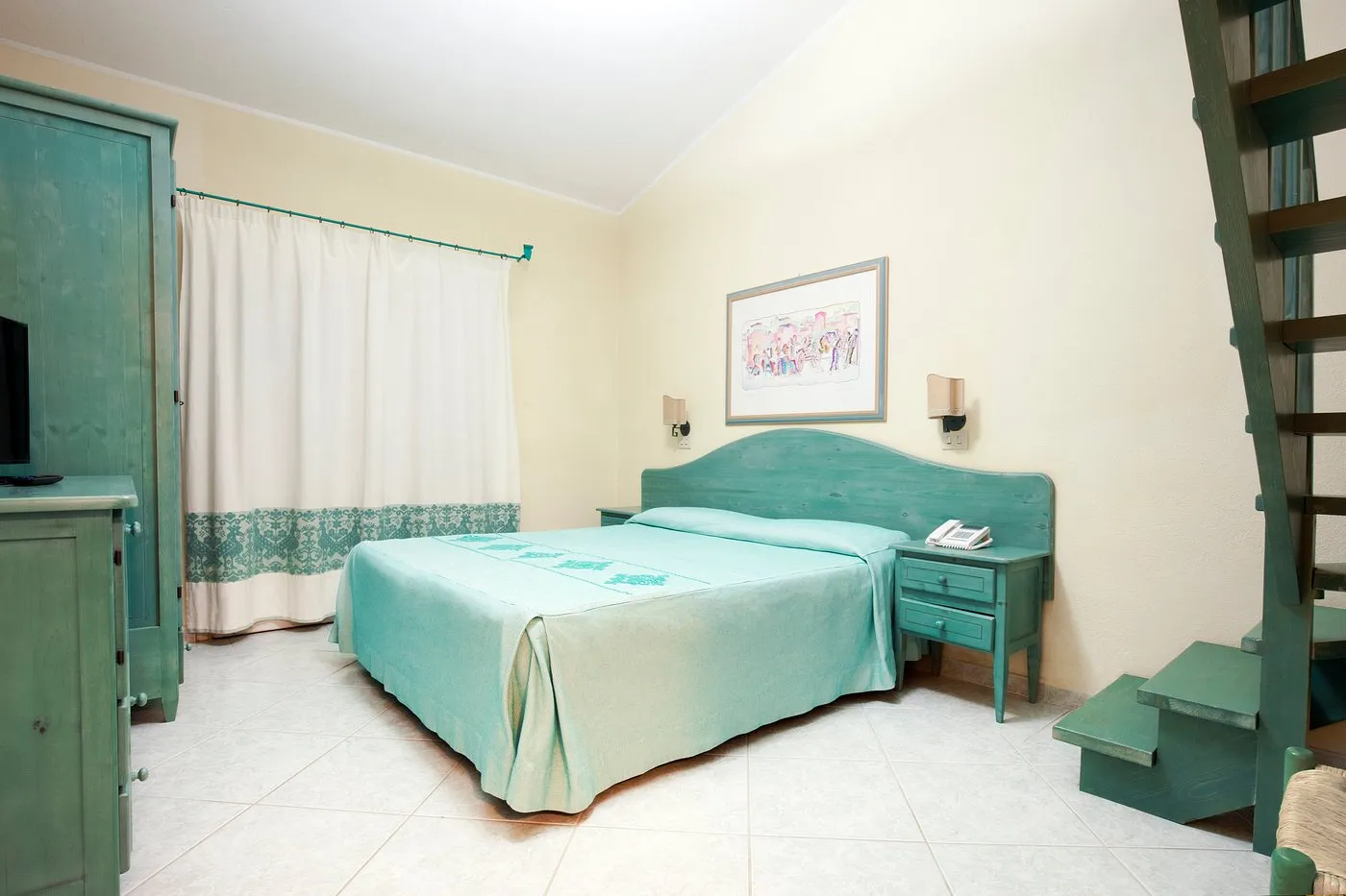 Camera con letto matrimoniale verde acqua, arredi e scala interna