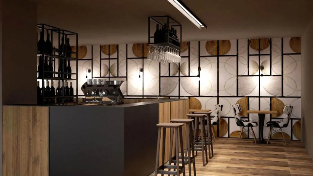 Area bar con bancone in legno, sgabelli alti e parete decorativa con bottiglie di vino